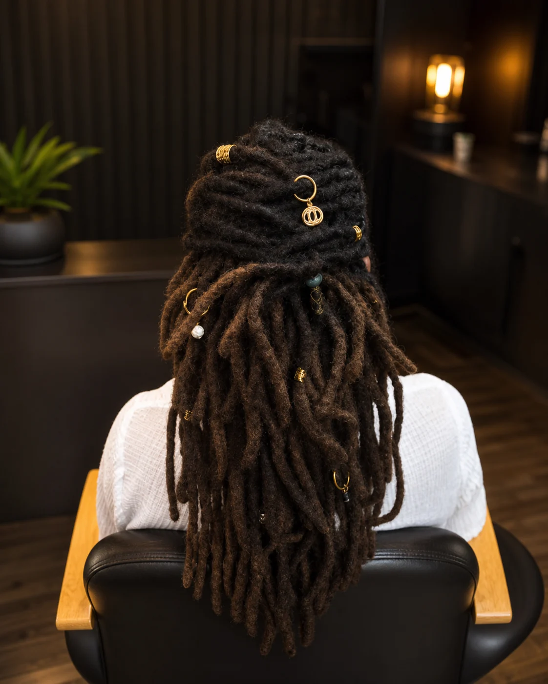 Mature locs gathered half-up with gold cuffs