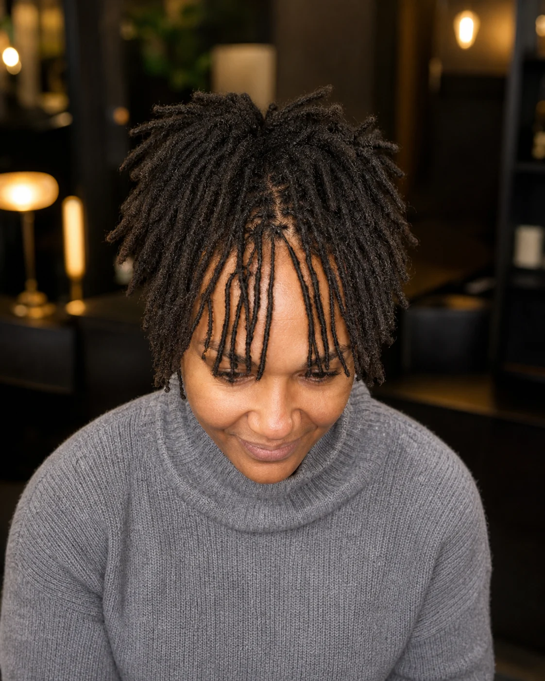 Short freeform locs framing the forehead